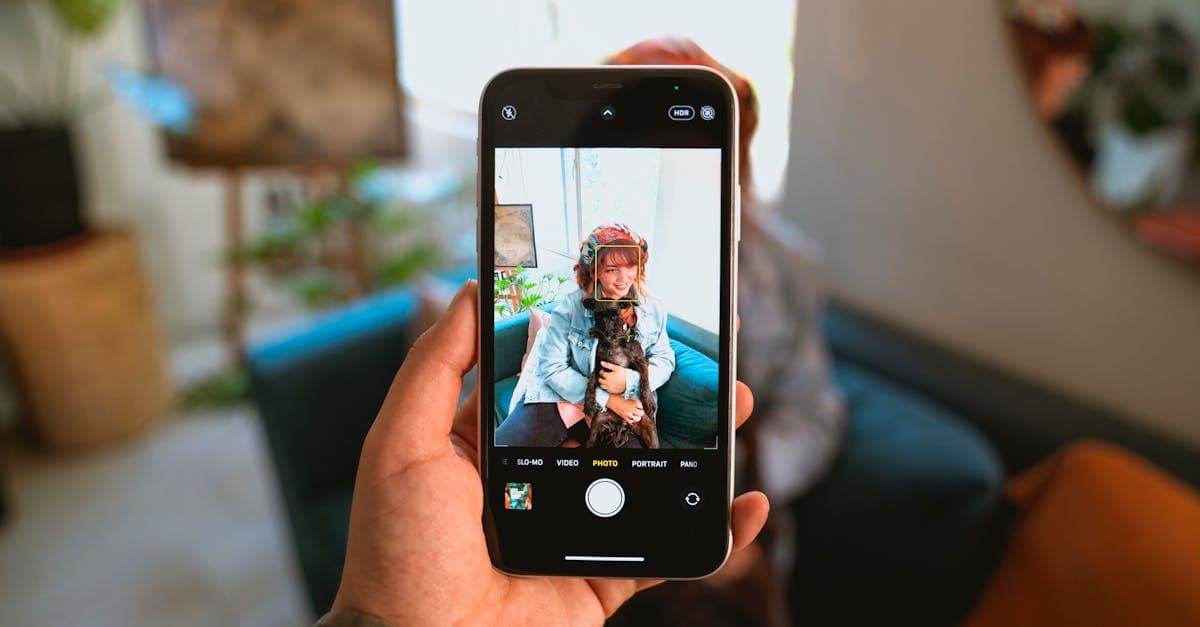 A woman holding her dog, captured through a smartphone indoors with modern decor.