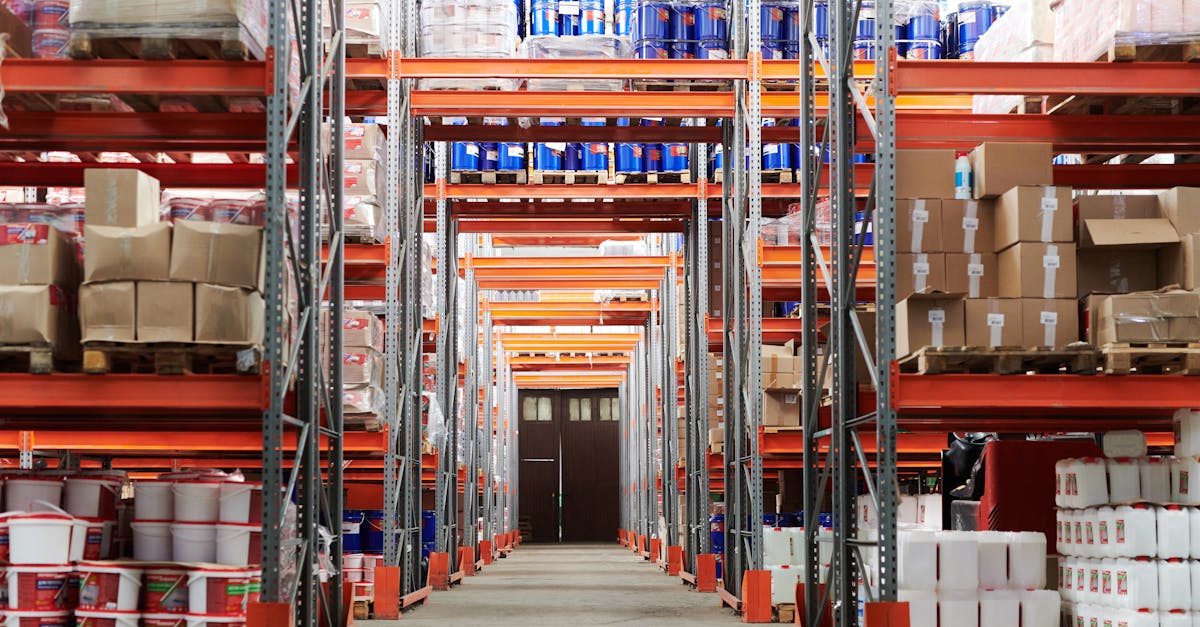 Wide angle view of a warehouse with stocked shelves and boxes.